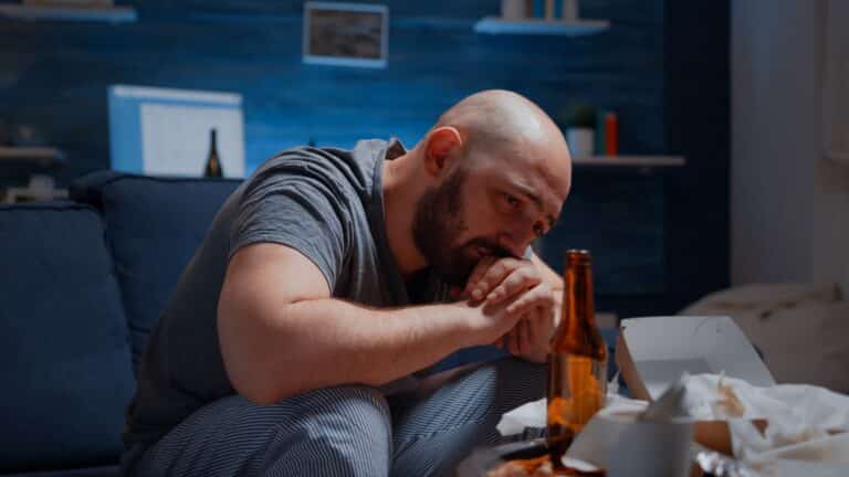 Depressed man crying feeling loneliness, chronic fatigue